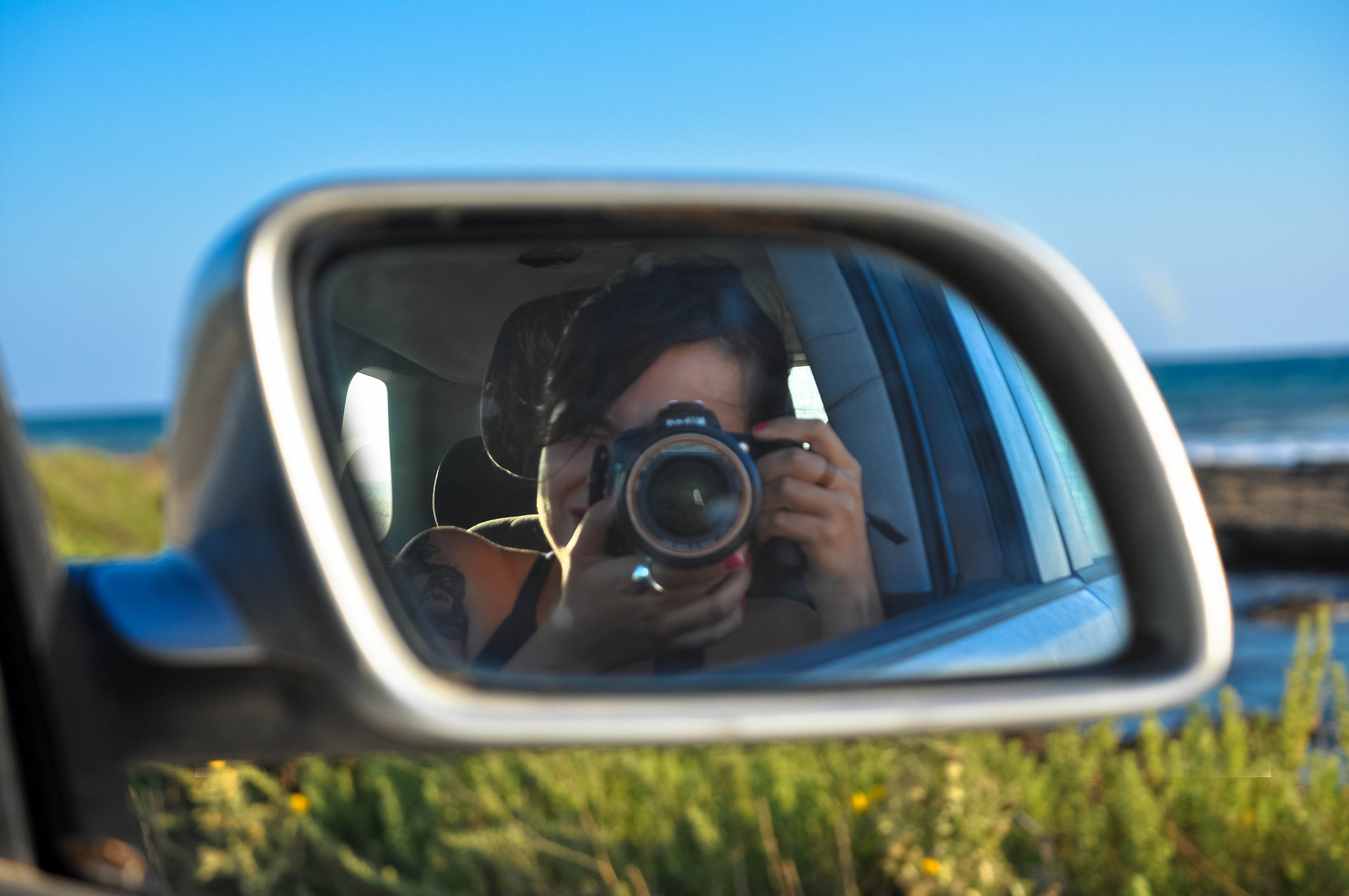 Connie Ram self portrait through car mirror